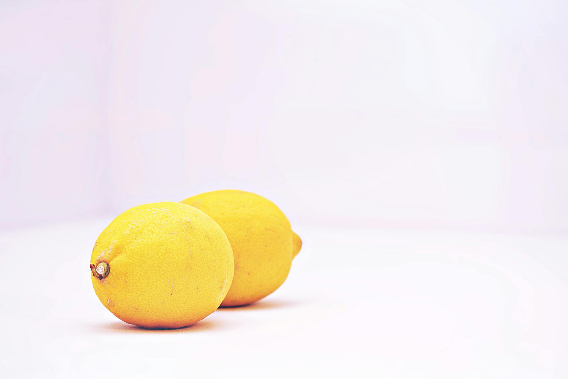 Two vibrant lemons against a white background symbolizing the lemon clitoral vibrator