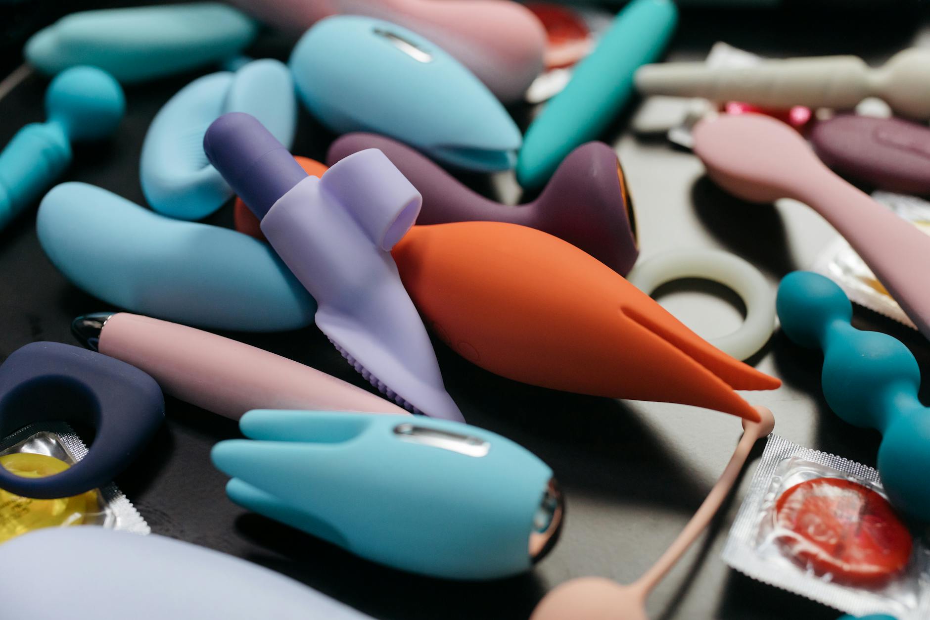 A blue silicone sex toy held in hand, symbolizing self-compassion and gentle pleasure during recovery.