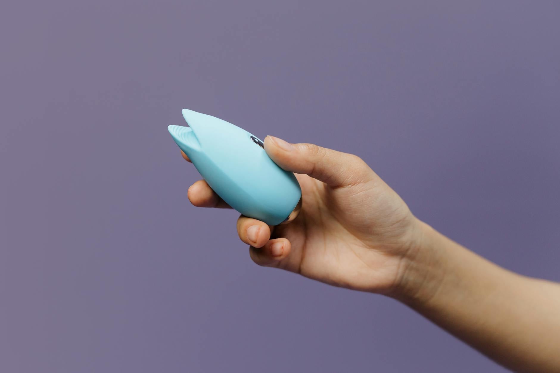 Colorful lemon clitoral vibrators on a bright yellow background in a studio setting