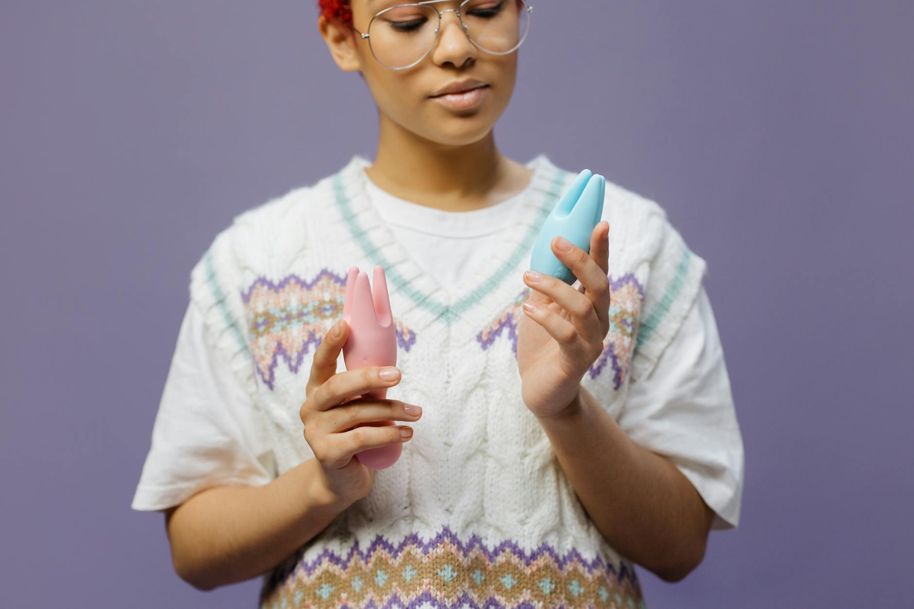 Woman holding a blue silicone lemon vibrator in contemplative hands