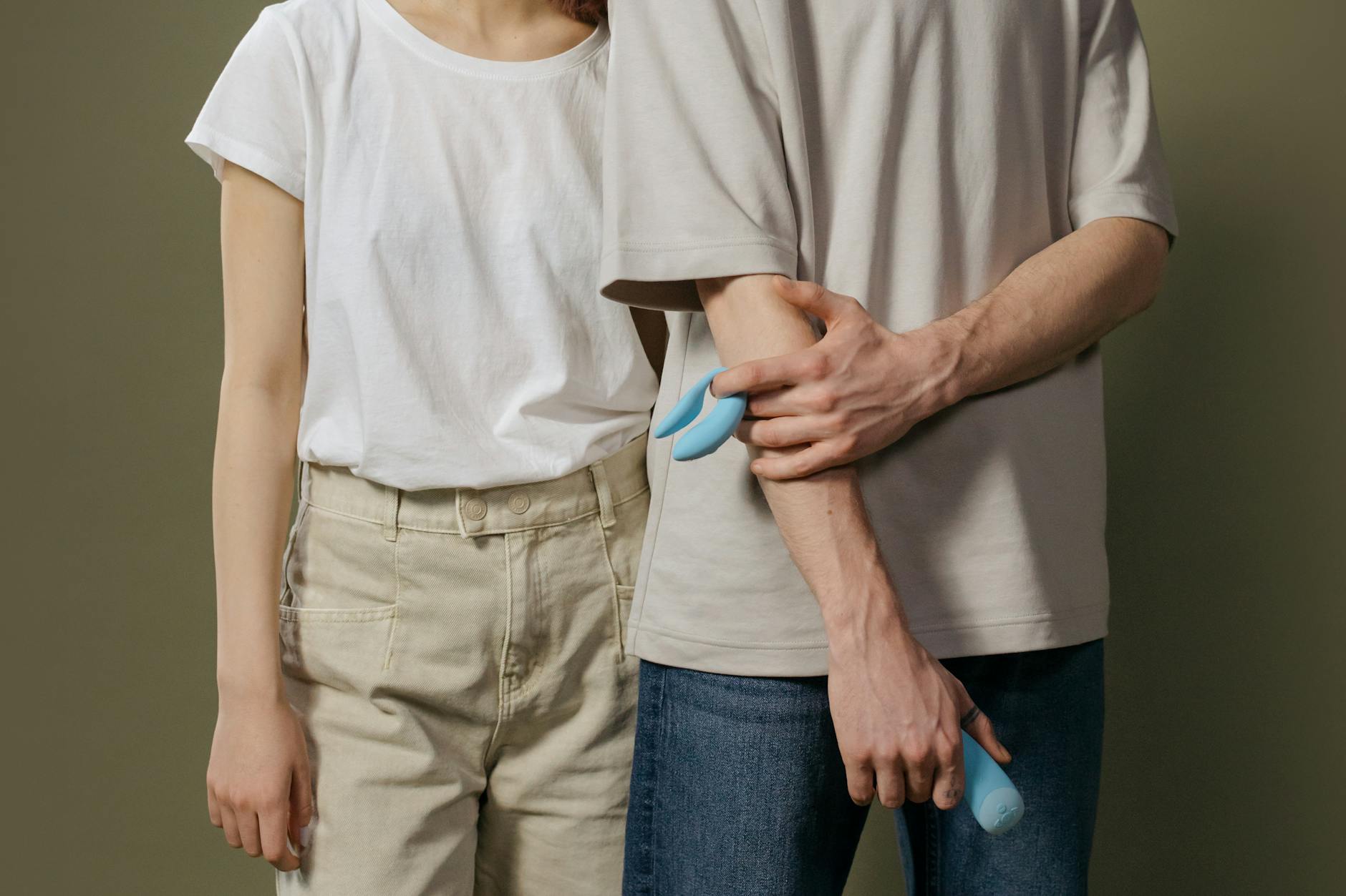 A couple holding a lemon vibrator together indoors, symbolizing shared intimacy after childbirth